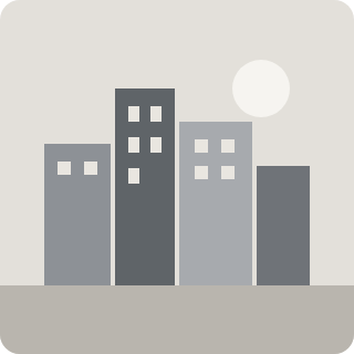 A row of city buildings under a pale sun
