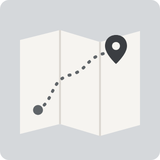 A folded map with a dotted route and a pin